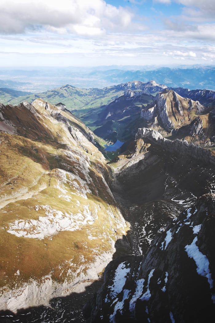 A stunning aerial view of the Swiss Alps in Hundwil, showcasing towering peaks and lush valleys.